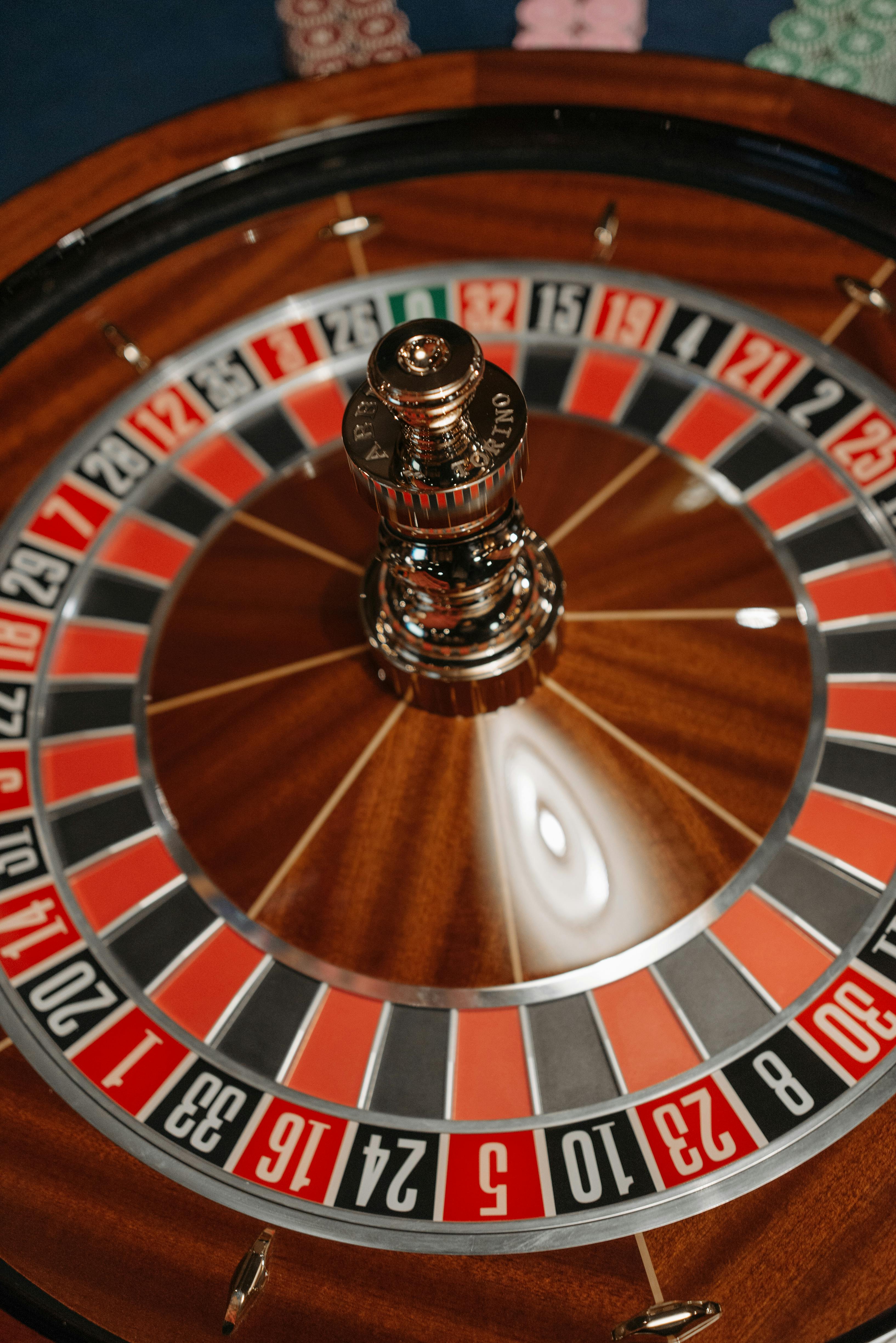 Vibrant close-up of a roulette wheel spinning in a casino setting.